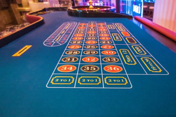 Close-up of Texas Poker table showing community cards, betting terminals, and dealer position
